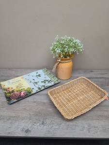 lot 389 image: Woven Basket Tray with Braided Rim, Glass floral tray, and a yellow metal bucket with floral arrangement