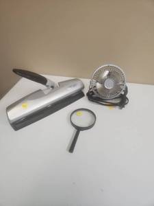 lot 554 image: Swingline 3-hole punch, small desk fan and magnifier