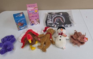 lot 588 image: Toy Lot Plush Animals, Pop-Up Animal Plush in box, Acrylic Bracelets new in box, and a monster face lunch box new in bag