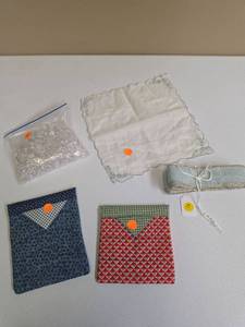 lot 594 image: Craft lot - small acrylic beads (good for vase decor), vintage handkerchief w embroidery, ribbon, and 2 small pop open storage quilted pouches