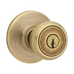 lot 1100 image: Kwikset Tylo Antique Brass Entry Door Knob 1-34 in.