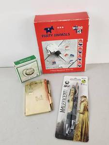 lot 398 image: Lot Party Animals Wine Set, InkWorks Maleficent Gel Pens, Tea Infuser, Notepad Lot
