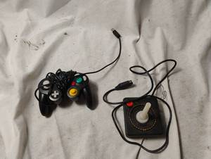 lot 34439 image: Vintage Nintendo controller and Atari 2600 CX-40 joystick