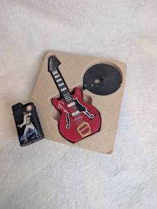 lot 1023 image: Elvis Presley Miniature Guitar Candle  Lighter Set