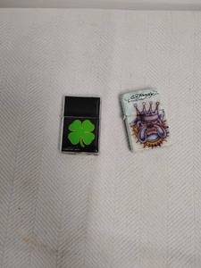 lot 40 image: Lot of 2 Lighters Kalan Four-Leaf Clover, Ed Hardy Crown, Don Ed Hardy Designs
