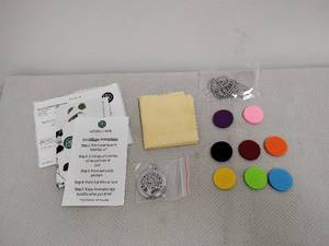 lot 71 image: Naturally Made Essentials Car Diffuser Kit with 9 Colored Pads and Pendant