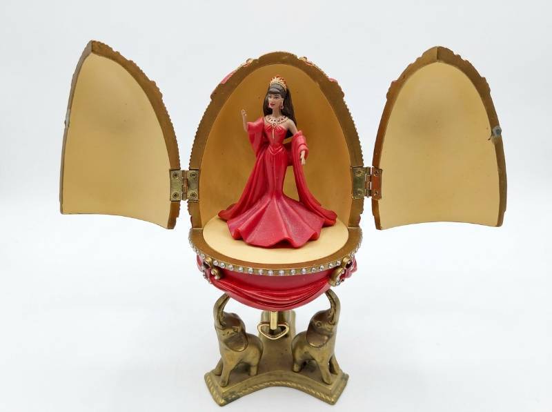lot 3880 image: Avon Barbie Countess Of Rubie 2001 Red Resin Egg Brunette Musical Display