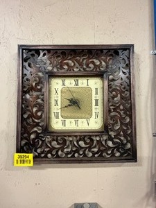 lot 35294 image: Square Decorative Wall Clock With an Ornate, Carved Floral and Cream Colored dial Featuring Roman Numerals & Inner Geometric Patterns.