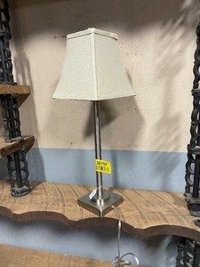 lot 35192 image: Silver base table lamp with a cream-colored shade