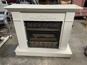 lot 35204 image: White freestanding Gas fireplace mantel with carved floral and fluted column details.