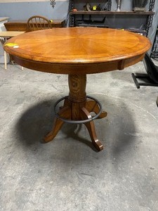 lot 35205 image: Round oak pedestal table with a distinctive circular metal footrest ring attached to the lower pedestal base