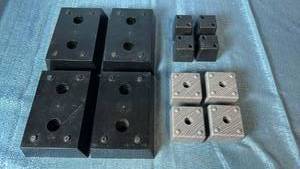 lot 2002 image: Lot of 12 Plastic Square Furniture Feet. Includes Three Different Sizes.