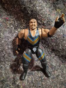 lot 4 image: Wrestling Action Figure with Black and Blue Attire Yellow Triangle Trim