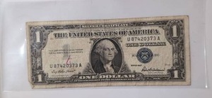 lot 409 image: One Dollar United States Blue Seal Silver Certificate 1935A U87120373A