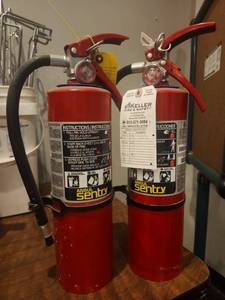 lot 12853 image: (2) Ansul Sentry Dry Chemical Fire Extinguishers w Hose and Wall Brackets