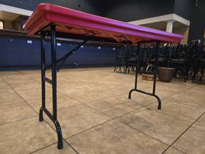 lot 12974 image: Red Plastic Folding Table with Adjustable-Height Black Steel Legs