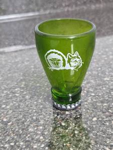 lot 181 image: Green Shot Glass with Embossed Character Design