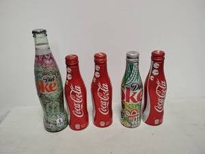 lot 47 image: Lot of five Coke bottles