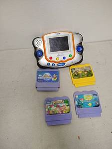 lot 118 image: VTech V.Smile Pocket Game Console with 4 Game Cartridges
