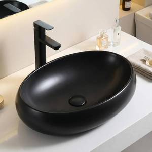 lot 71 image: Matte Black Ceramic Oval Vessel Sink Bowl, Countertop Bathroom Vanity Installation, Slim Rim Modern Designer Wash Basin, Easy Clean Glaze, 24 x 16 x 6 in - Retail $310