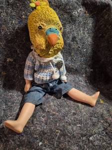 lot 42 image: Doll with Yellow Bird Head Mask Sweater and Jeans