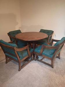 lot 930 image: Vintage Round Wooden Table with 4 Tavern, Captain Chairs.  Top needs repaired. Table  26 x 40.  Located in basement