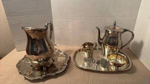 lot 1007 image: Silver plated coffee pot, water pitcher, platters and more