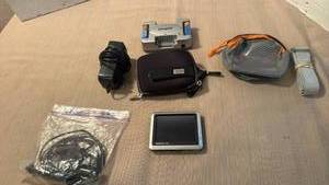 lot 1012 image: Garmin nuvi with case and car charger, energizer battery charger and more