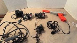 lot 1030 image: Nintendo controllers and controller gun with various cords
