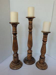 lot 1126 image: Set of 3 Wooden Candle Holders with Cream Pillar Candles. Largest stands 23 in without candle.