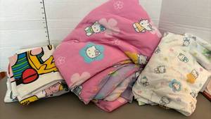 lot 1414 image: Twin size Hello Kitty Comforter and sheet and a Snoopy twin size sheet with pillow case