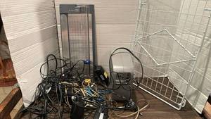 lot 2053 image: Belkin Battery Backup, cords and chargers, metal rack and paper cutter - all in a green milk crate