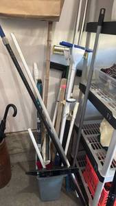 lot 3103 image: Cleaning Tool Storage Organizer Lot with Brooms Mops Dustpans Brushes and more