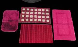 lot 3322 image: 4-Piece Red Bath Mat or rug Set with Striped and Checkered Patterns. Largest is 36x22