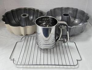 lot 1105 image: Baking Lot-2 Fluted Cake Pans, Flour Sifter, Wire Rack - Retail $0
