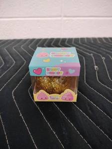 lot 141 image: Brady Budeey Gold Glitter Poop Emoji Squishy Toy in Display Box