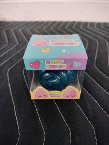 lot 142 image: Brady Budeey Blue Glitter Poop Emoji Squishy Toy in Display Box