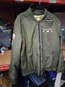 lot 551 image: Nike Dallas Cowboys Salute to Service Reversible Bomber Jacket Olive Camo