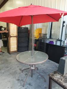 lot 2709 image: Round Patio Table with Red Offset Umbrella