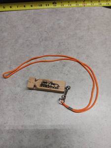 lot 3224 image: Wooden Train Whistle with Locomotive Print and Orange Lanyard