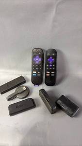 lot 528 image: Roku and Amazon Streaming Sticks and remotes (untested)