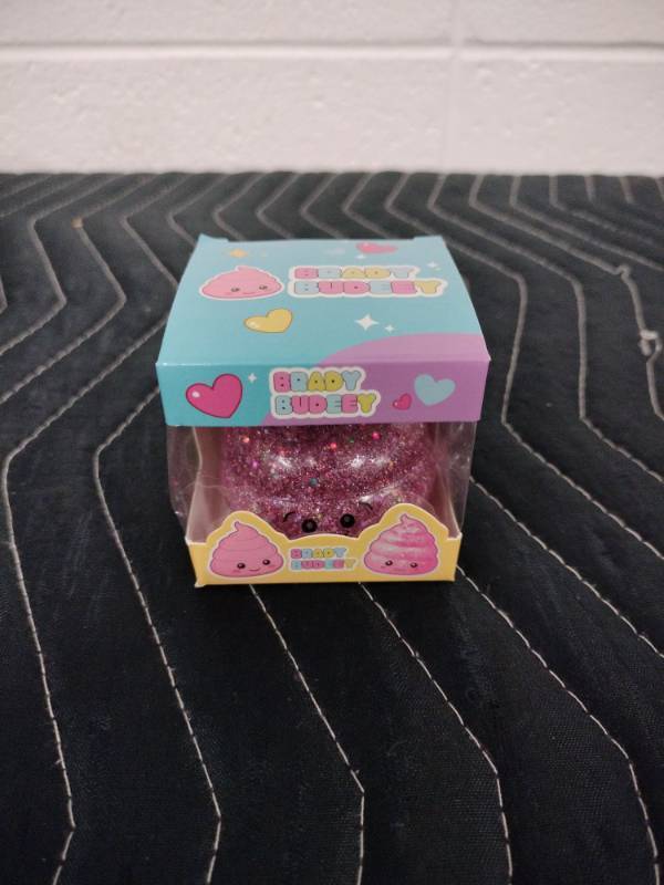 lot 144 image: Brady Budeey Pink Glitter Poop Emoji Squishy Toy in Display Box