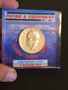 lot 18 image: Eisenhower Bicentennial half dollar paper weight