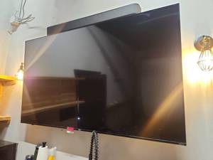 lot 18765 image: 75in  Onn Roku TV Wall-Mounted Flat Screen Television w Remote and Soundbar