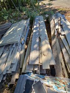 lot 21922 image: Lot of Textured Wood-Grain Siding Panels and Strips, Assorted Lengths