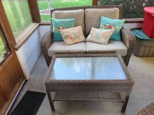 lot 807 image: Porch glider wicker settee, 36x50x38, floor to seat, 19in. with removable cushions and throw  pillows, plus glass top coffee table, 21x34x20
