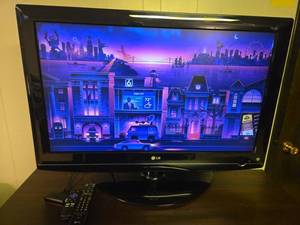 lot 827 image: LG TV 37in. with Roku and remotes, plus BluRay player, located in basement