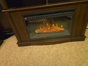 lot 828 image: Electric Fireplace Insert with Wood Cabinet, 33x44x15, and Remote Control, located in basement