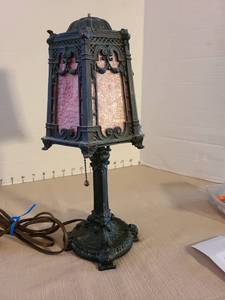 lot 1021 image: Ornate metal table lamp with pink glass panels, 13in tall, missing finial.