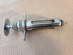 lot 1029 image: Vintage Dura-Viking Randall Syringe Co. Glass Syringe with Plunger with small glass measuring cup